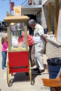 Bernie Green manning the museum's popcorn machine on opening day.